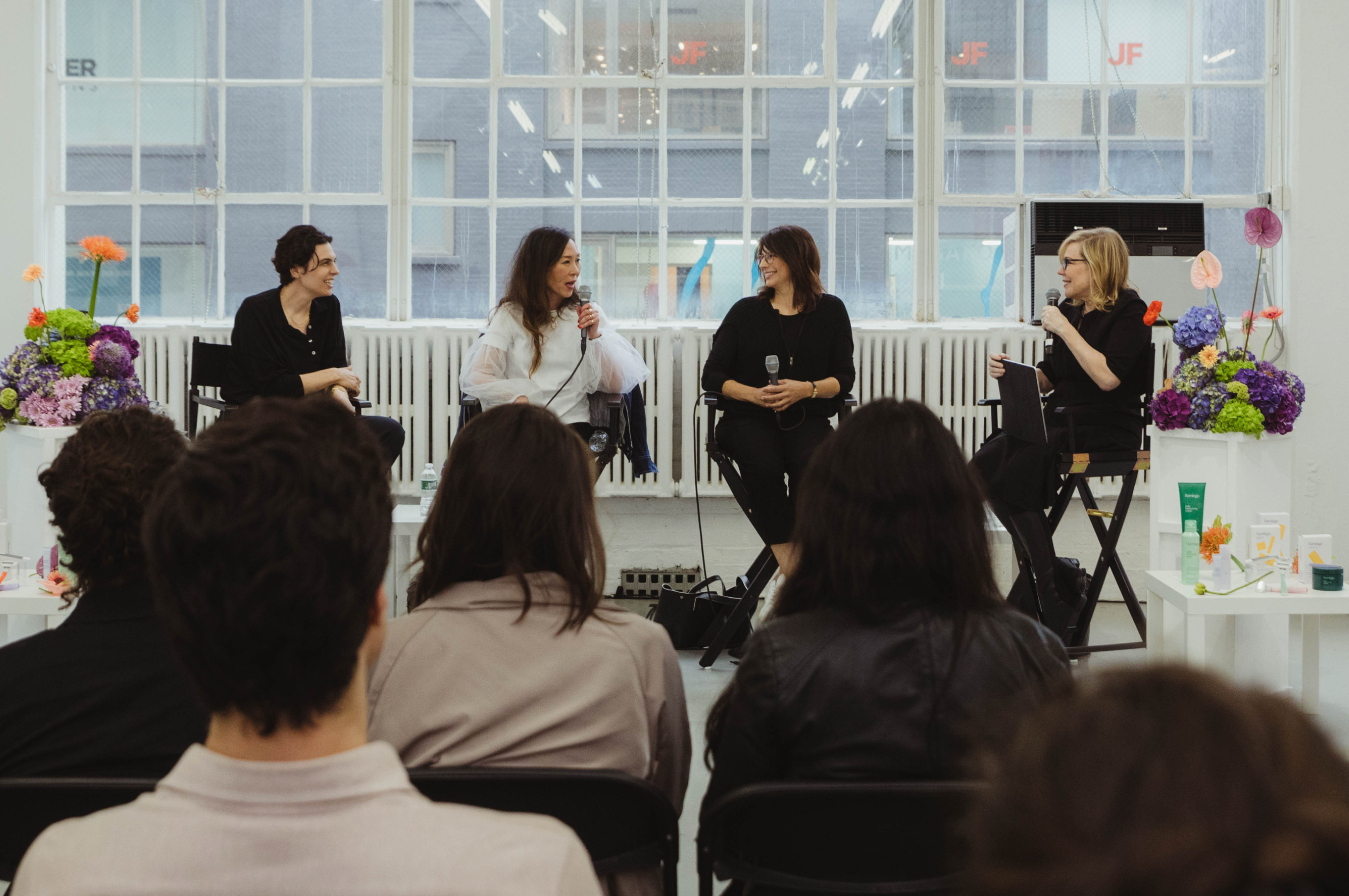 Four women in panel discussion in front of audience